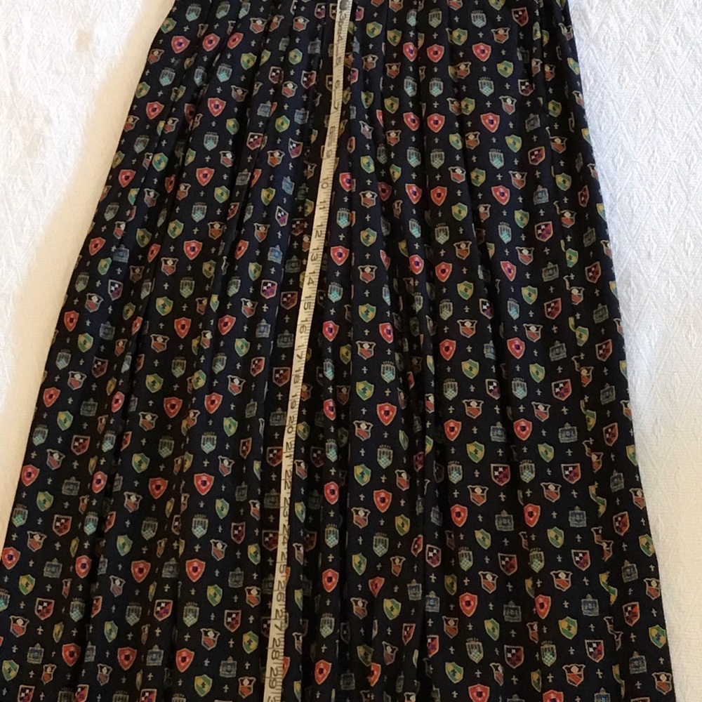 Chaus front-pleated skirt with one-button closure.
